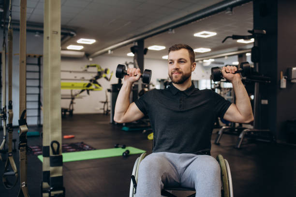istock Hardworking person with a disability exercising with weights in the gym 2140496961