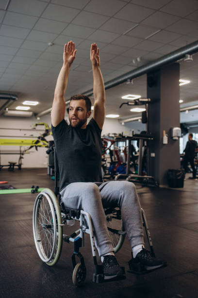 istock Hardworking person with a disability exercising with weights in the gym 2140496969