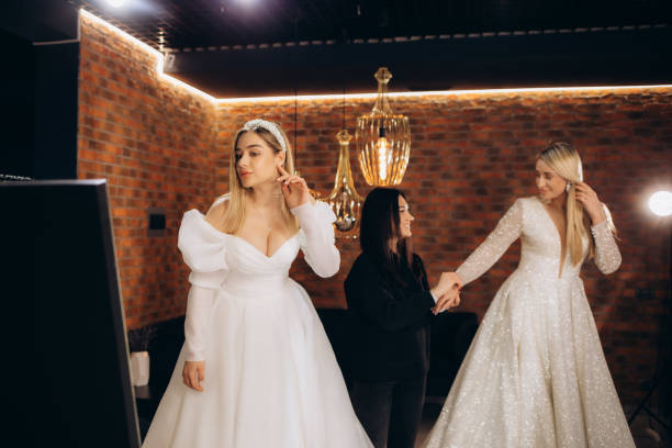 istock Two beautiful brides trying on wedding dresses 2140523198