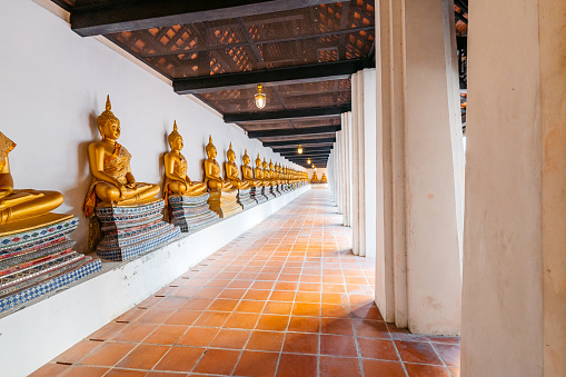 The sitting buddha statues inside of Wat Phutthaisawan In Ayutthaya Historical Park in Thailand.