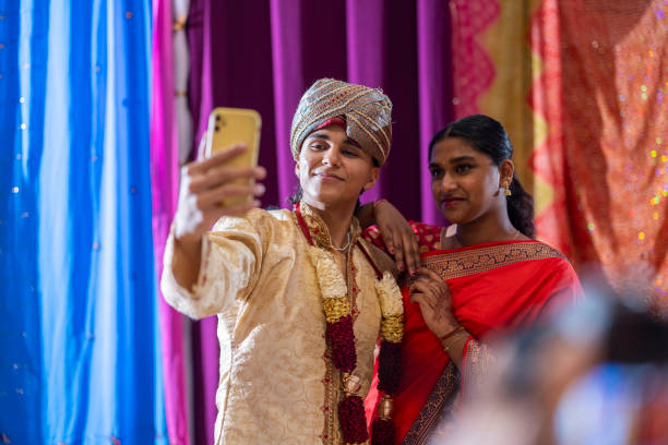 istock Smiling Indian Woman Taking Selfie in Red Saree 2140541486