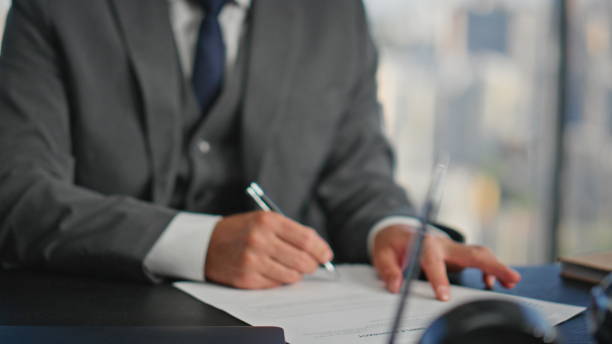 istock Executive hands signing papers in office closeup. Smiling businessman planning 2140555225