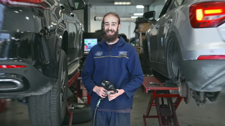 Technician change tire. Mechanic unscrews bolts car service. People profession.