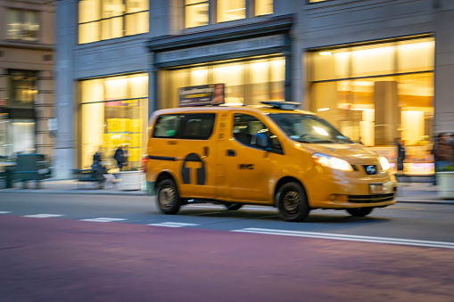 Manhattan, New York, USA - March, 2024.  Yellow cab on a Manhattan street.