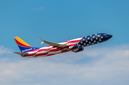 Denver, CO - July 9, 2023: The Southwest Airlines specially painted Freedom One Boeing 737-800 departs from Denver International Airport.  On June 18, 2021, Southwest unveiled the Freedom One plane for their 50 years of giving people the freedom to fly.  From SWA: \n\