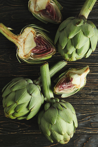 Concept of healthy food with artichoke on wooden background