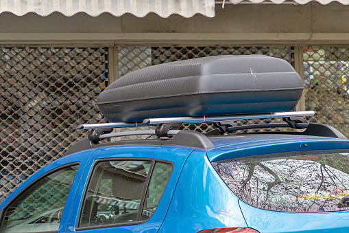 Large plastic box on a car roof used for storing items inside