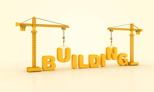istock BUILDING Word with Tower Crane 2140625993