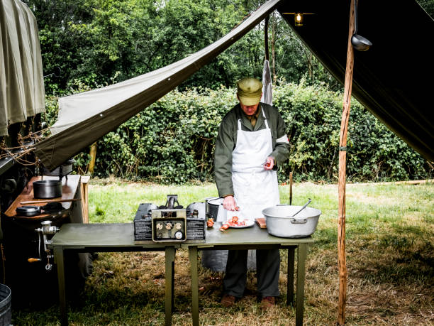 Second world war commemoration. Military camp reconstitution Authentic scene of unidentified army cooker with table tools onions.