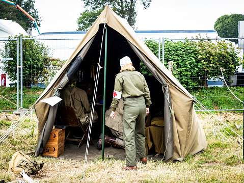 Second world war commemoration. Military camp reconstitution Unidentified woman and man soldiers next to army tent.