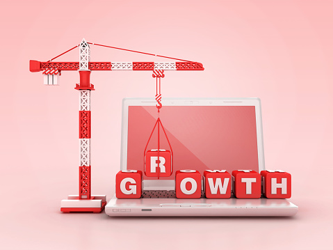 GROWTH Blocks with Tower Crane on Computer Laptop - Color Background - 3D Rendering