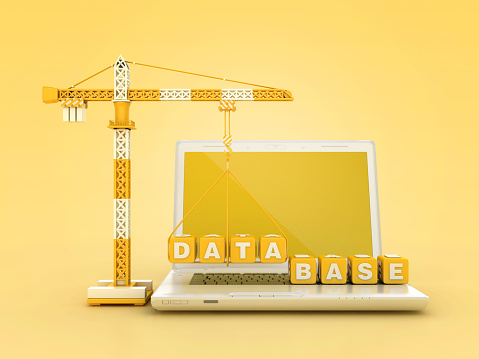 DATABASE Blocks with Tower Crane on Computer Laptop - Color Background - 3D Rendering