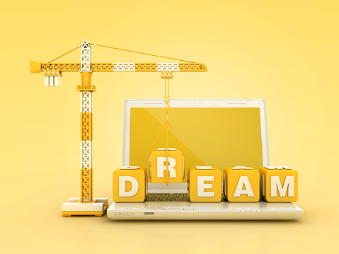 DREAM Blocks with Tower Crane on Computer Laptop - Color Background - 3D Rendering
