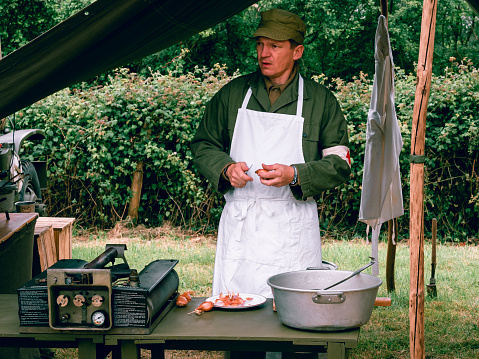 Second world war commemoration. Military camp reconstitution Authentic scene of unidentified army cooker with table tools onions.