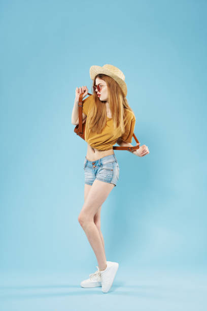 istock pretty woman elegant style hat sunglasses posing blue background 2140643519