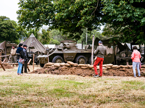 Second world war commemoration. Military camp reconstitution Unidentified soldiers people next to tents, military american war vehicles.