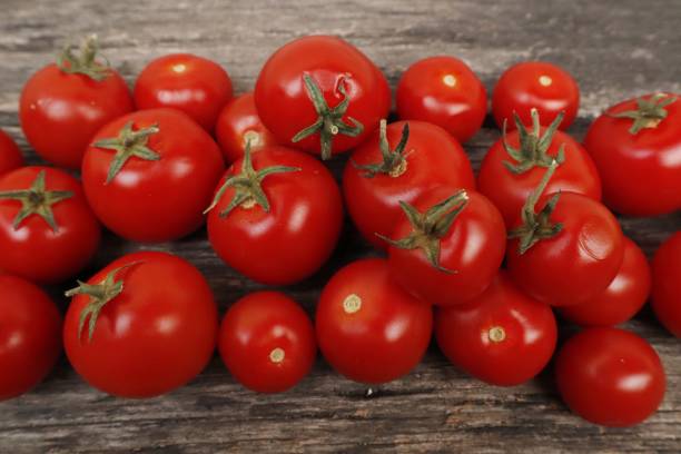 istock Fresh organic tomatoes on a wooden table using the Hydroponics method. Plants that nourish the skin help to brighten the skin. 2140650412