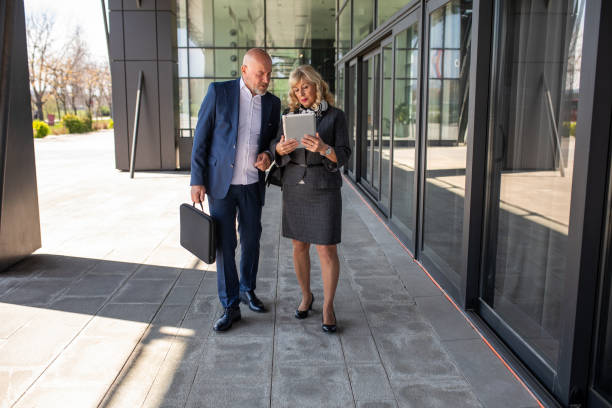 istock Business persons talking outside their workplace 2140662598