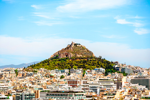 Athens, Greece - March 6 2022: Panorama of the Athens' skyline with the Lycabettus Mount. Photo taken from the Acropolis hill.
