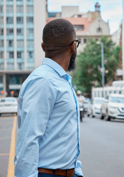 istock Confident Black Man in Business Attire Against Urban Backdrop Looking Away 2140692425