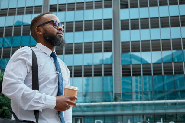 istock Confident Black Businessman Outside Modern Office Building Holding Coffee 2140692439