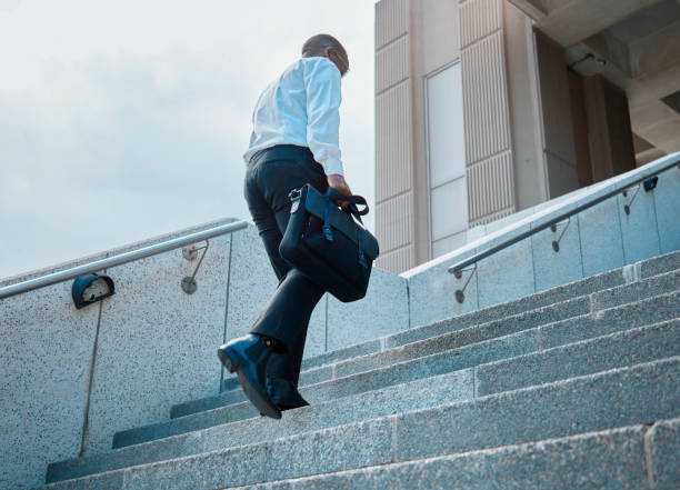 istock Confident Black Businessman Climbing Stairs in the City 2140692995