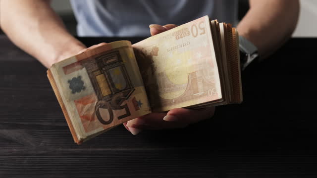 Girl Holding In Hands Bundle Of Hundred Euro Bills