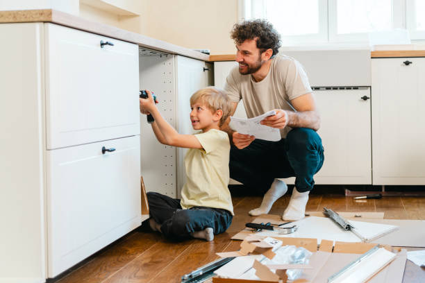 istock Father and son assembling kitchen furniture 2140777792
