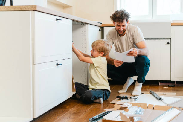 istock Father and son assembling kitchen furniture 2140778326