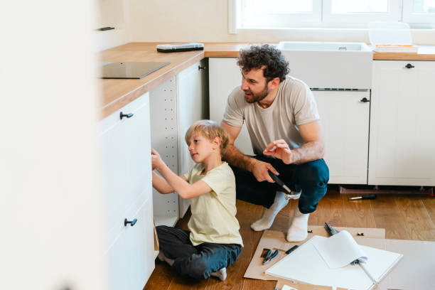 istock Father and son assembling kitchen furniture 2140778329