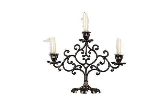Bronze chandelier with extinguished candles isolated on a white background.