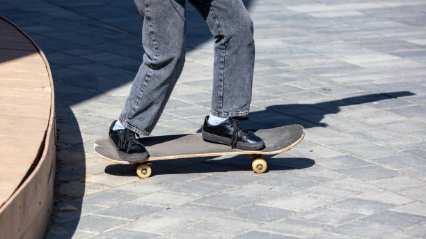 istock A girl riding a skateboard on paving slabs 2140805675