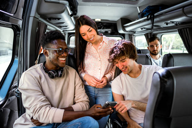 istock Friends looking at smartphone together while traveling by bus 2140816513