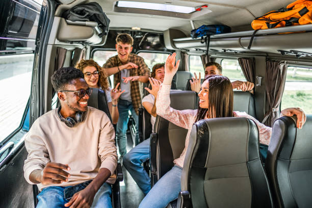istock Friends enjoying music while riding a bus on a field trip 2140825935