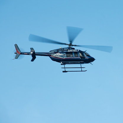 Life Flight Network medical transport helicopter in flight. Taking off / landing at Sacred Heart Medical Center in Spokane, Washington USA.