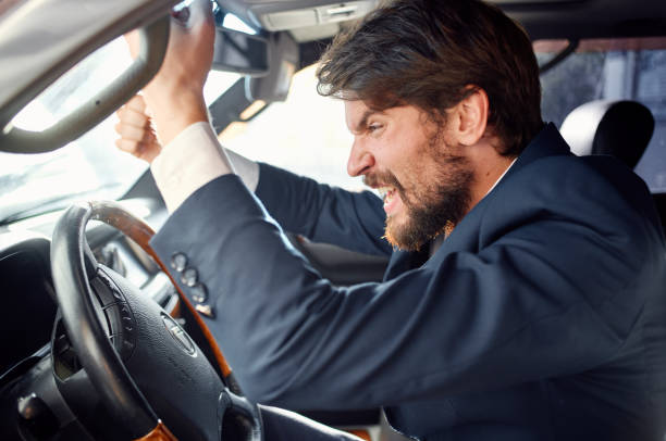 istock emotional man driving a car gesturing with his hands road track 2140832462