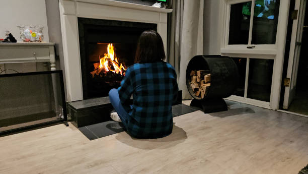 istock Woman Sitting on the Floor by Fireplace 2140842690