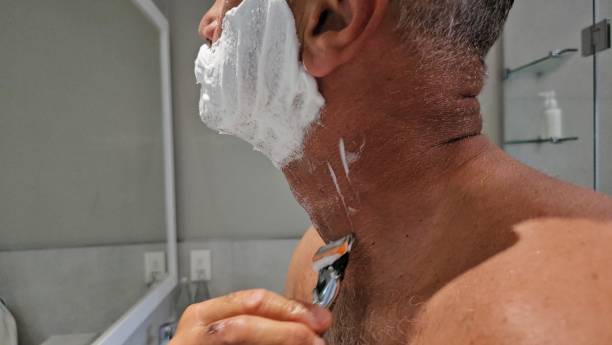 istock Man Shaving His Face in the Bathroom 2140843716