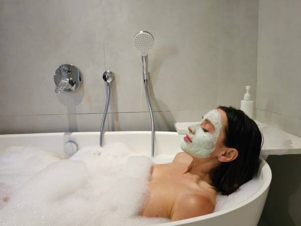 istock Woman in Bathtub With Face Mask 2140846318