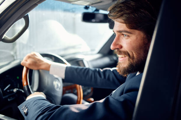istock man driving a car trip road official wealth 2140860381