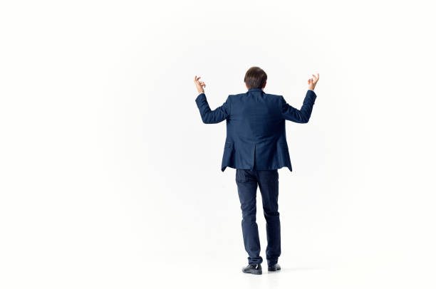 business man puzzled look light background suit gesturing with hands finance and work model. High quality photo