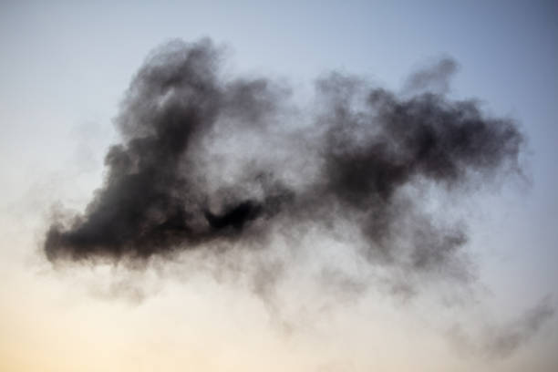 Black smoke against a blue sky.