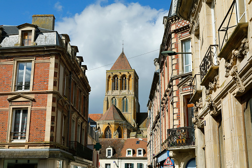 Street with historic residential buildings and the Benedictine Abbey in the background