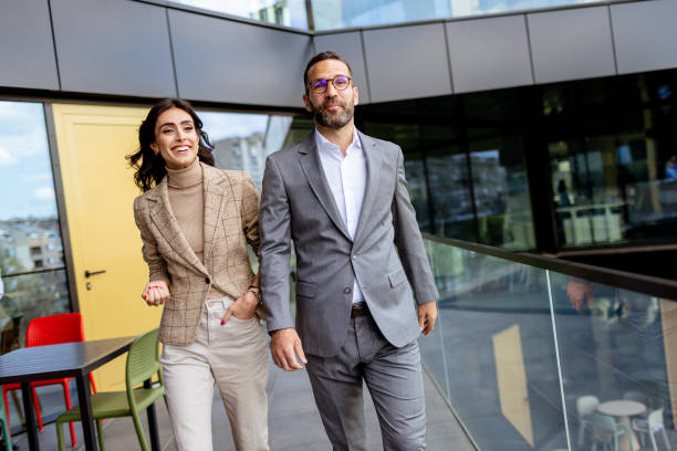 istock Cheerful Colleagues Exiting a Modern Office Building on a Bright Afternoon 2140912115