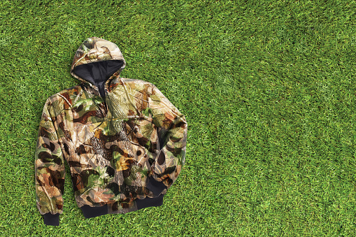 Camo hoodie on a grass lawn background