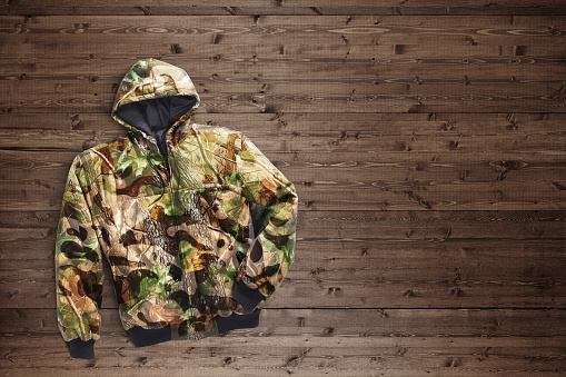 Camo hoodie on a wood background
