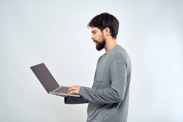 istock A man in a gray sweater with a laptop hands lifestyle technology communication internet work 2140944070