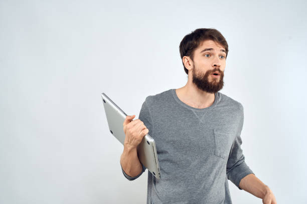 istock Man with laptop in hands technology internet self-confidence light background 2140953156