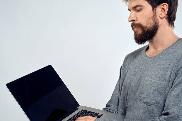 istock A man in a gray sweater with a laptop hands lifestyle technology communication internet work 2140963745