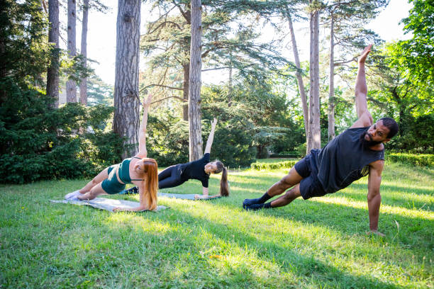 istock Three people are doing high side plank hold a park training together 2140971748